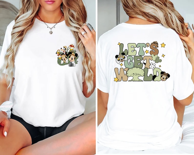 May include: White t-shirt with a pocket featuring a cartoon image of Mickey Mouse and friends in a jungle setting. The back of the shirt has a graphic that says "Let's Get Wild" with cartoon images of Mickey Mouse and friends.
