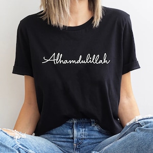 May include: A black t-shirt with the word "Alhamdulillah" written in white cursive script.