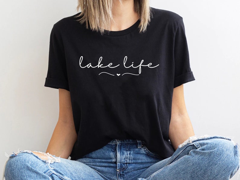 May include: Black t-shirt with white text that says "lake life" with a small heart symbol.
