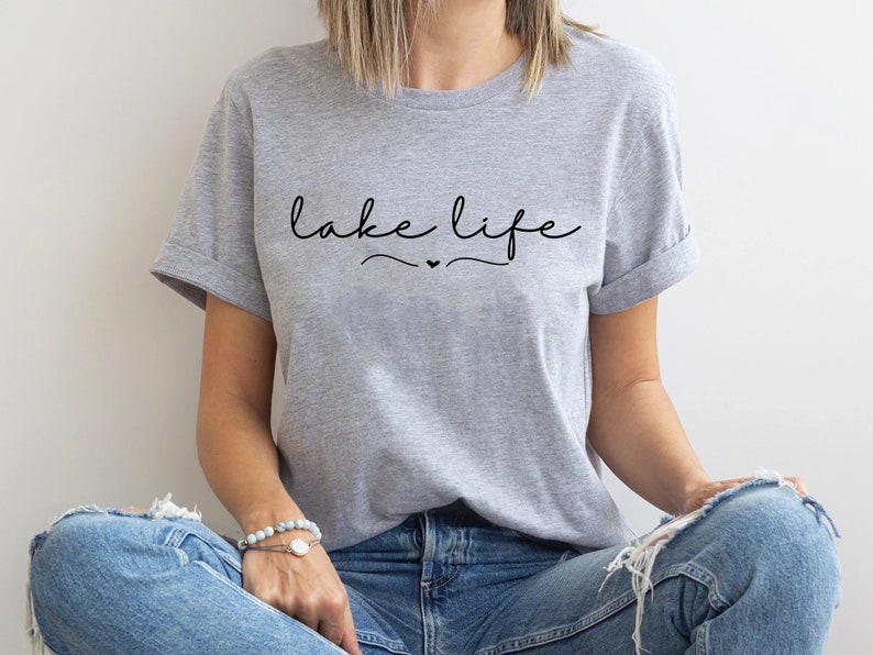 May include: A gray t-shirt with the text "lake life" in black cursive lettering with a small heart symbol.