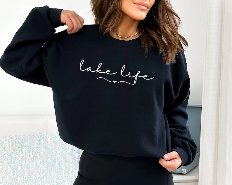 May include: Black sweatshirt with the text "lake life" in white cursive lettering.