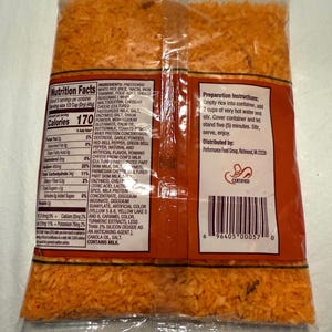 May include: A bag of orange-colored precooked rice mix with a nutrition facts label and preparation instructions. The label lists the ingredients, including white rice, cheese seasoning, whey, maltodextrin, cheddar cheese, salt, onion powder, and more. The bag also has a barcode and a "Certified" logo.