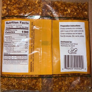 May include: A clear plastic package containing a dry food product. The package has a yellow label with nutritional information, preparation instructions, and a barcode. The ingredients include pinto beans, rice, and spices.