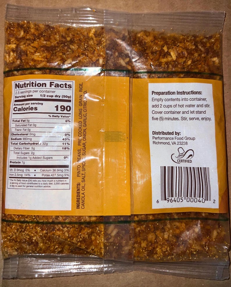 May include: A clear plastic package containing a dry food product. The package has a yellow label with nutritional information, preparation instructions, and a barcode. The ingredients include pinto beans, rice, and spices.