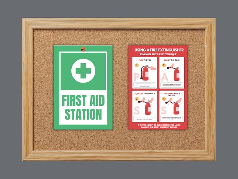 May include: A corkboard with a wooden frame displays a green and white "First Aid Station" sign and a red fire extinguisher guide. The fire extinguisher guide shows the PASS technique: Pull, Aim, Squeeze, Sweep.