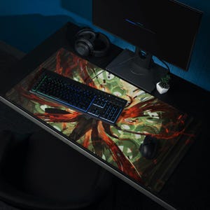 May include: A black keyboard with rainbow backlighting sits on a colorful abstract design mousepad with a black computer mouse and headphones.