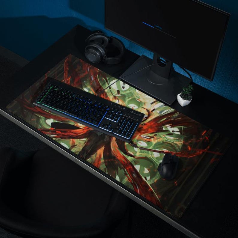 May include: A black keyboard with rainbow backlighting sits on a colorful abstract design mousepad with a black computer mouse and headphones.