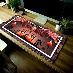 May include: A large, rectangular mouse mat with a dark brown background and a white border. The centre of the mouse mat features a colourful illustration of a winged figure with a halo, surrounded by other figures and a fiery background. The illustration is surrounded by a white border with a decorative pattern.