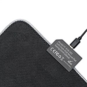 May include: A black and gray soft cloth RGB mouse pad with a USB cable connected to the pad. The pad has a white border and the text "Model: YF-RGB-001 Soft Cloth RGB Mouse Pad Rating: 5V=100mA CEFCO ROHS MADE IN CHINA" printed on the pad.