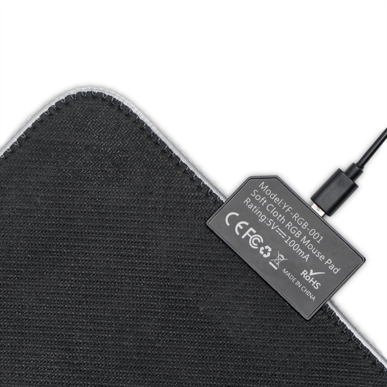 May include: A black and gray soft cloth RGB mouse pad with a USB cable connected to the pad. The pad has a white border and the text "Model: YF-RGB-001 Soft Cloth RGB Mouse Pad Rating: 5V=100mA CEFCO ROHS MADE IN CHINA" printed on the pad.
