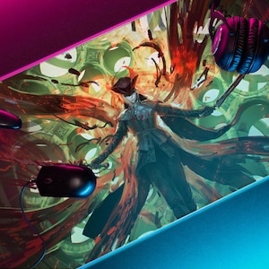 May include: A gaming mouse pad with a colorful, abstract design featuring a figure in a black coat and hat. The design includes red, orange, green, and blue colors. A black gaming controller and a pair of black headphones are also visible in the image.