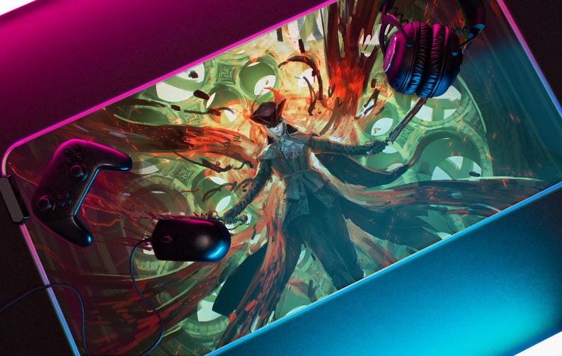 May include: A gaming mouse pad with a colorful, abstract design featuring a figure in a black coat and hat. The design includes red, orange, green, and blue colors. A black gaming controller and a pair of black headphones are also visible in the image.