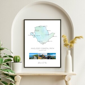 May include: Framed print of the Anglesey Coastal Path, featuring a map outline in shades of blue and green. The print includes the text "Anglesey Coastal Path August 2025" and three landscape photos. The frame is black.