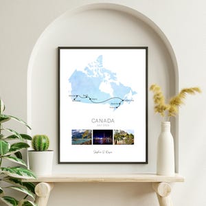 May include: A framed print displaying a watercolour map of Canada, highlighting a travel route. The print includes the text "CANADA JULY 2023" and three landscape photographs. The artist's name is at the bottom.