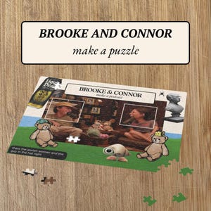 May include: A jigsaw puzzle featuring a photo of two people, Brooke and Connor, making a podcast. The puzzle is on a wooden surface with some puzzle pieces scattered around it. The puzzle box has the text "Brooke & Connor make a podcast" on it.
