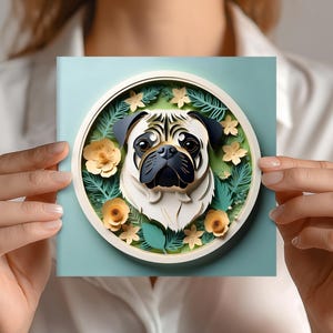 May include: A square, light blue card featuring a 3D illustration of a pug dog within a circular frame. The pug has a cream-colored face, black ears, and a black snout. The frame is decorated with yellow flowers and green leaves.