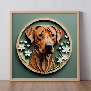 May include: A paper art portrait of a brown and black Rhodesian Ridgeback dog with white flowers surrounding the dog's head. The portrait is framed in a light brown wood frame.