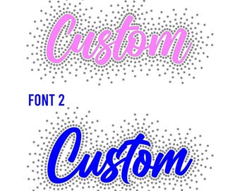 May include: Two "Custom" text designs in different fonts. The first is in pink with a dotted gray border and the text "FONT 1" above it. The second is in blue with a dotted gray border and the text "FONT 2" above it. All on a white background.