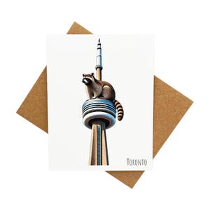 Carte de voeux de Toronto avec un grand raton laveur au sommet de la Tour CN [Légende : Toronto] - Livrée avec enveloppe