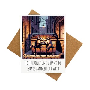 Carte de voeux Deux ratons laveurs en train de manger un dîner [Légende : Pour le seul avec qui je veux partager la lumière aux chandelles] - Livrée avec enveloppe