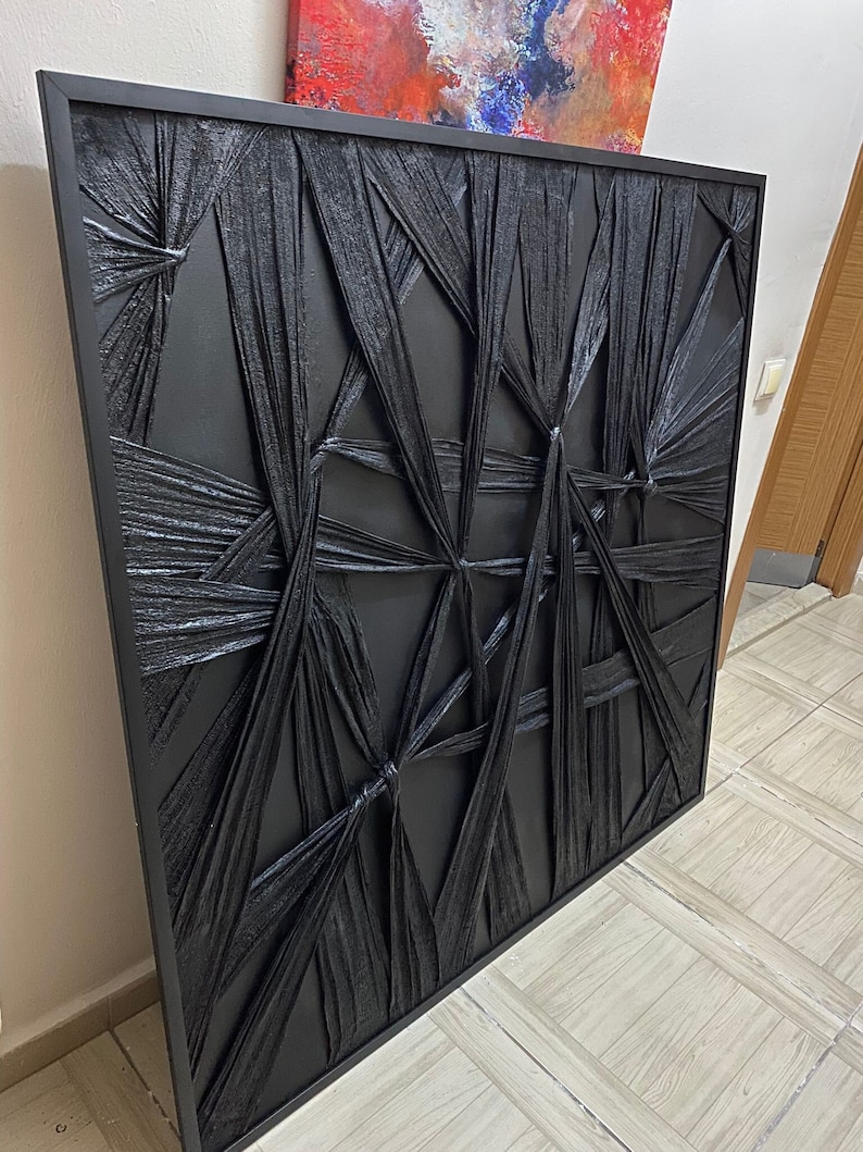 May include: Black and white abstract wall art with a textured, woven design. The art is framed in a black frame.