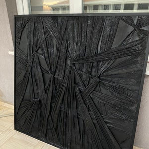 May include: Black and white abstract wall art with a textured, woven design. The art is framed in a black frame.