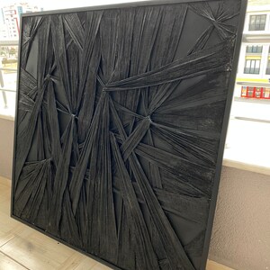 May include: Black and white abstract wall art with a textured, woven design. The art is framed in a black frame.