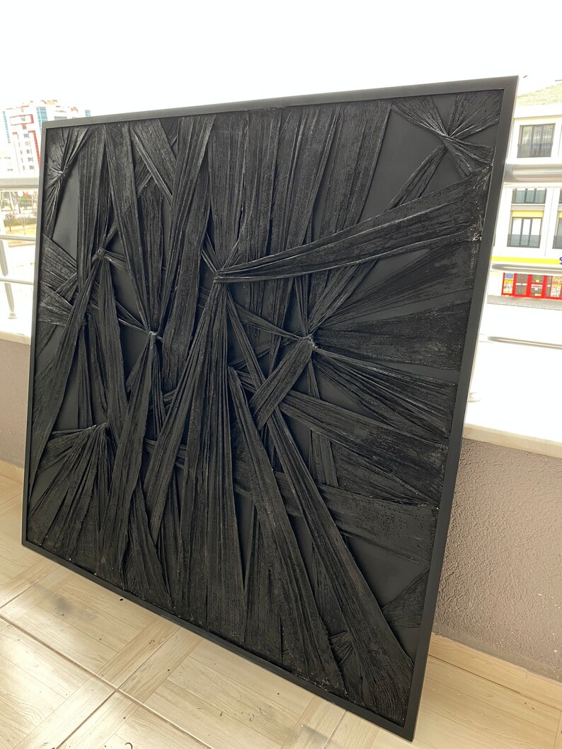 May include: Black and white abstract wall art with a textured, woven design. The art is framed in a black frame.