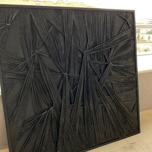 May include: Black and white abstract wall art with a textured, woven design. The art is framed in a black frame.