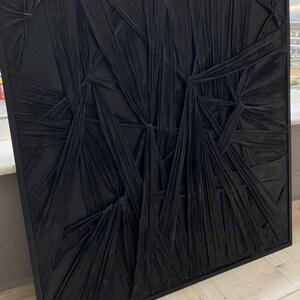 May include: Black and white abstract wall art with a textured, woven design. The art is framed in a black frame.