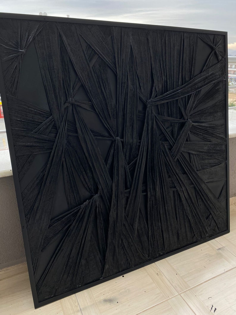 May include: Black and white abstract wall art with a textured, woven design. The art is framed in a black frame.