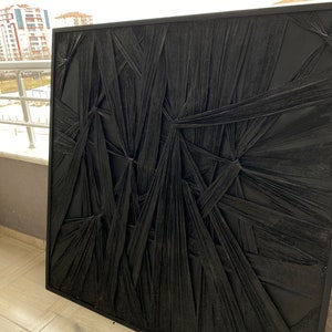 May include: Black and white abstract wall art with a textured, woven design. The art is framed in a black frame.