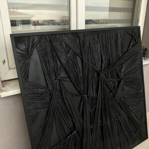 May include: Black and white abstract wall art with a textured, woven design. The art is framed in a black frame.