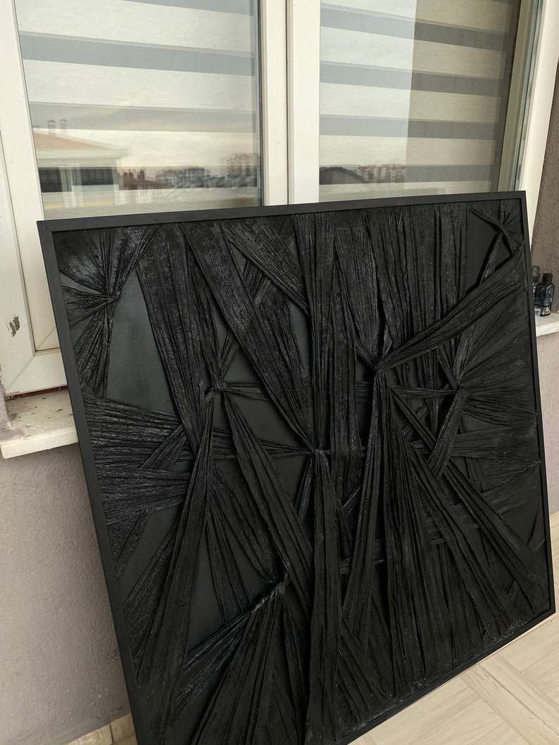 May include: Black and white abstract wall art with a textured, woven design. The art is framed in a black frame.