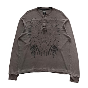 May include: A long-sleeved, dark grey shirt with a black graphic print of a stylised design with feathers. The shirt has a button-up collar and a single button on the front. The text "POINT ZERO" is printed on the label.