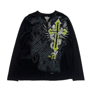 May include: Black long-sleeve shirt with a cross design. The cross is outlined in neon green and has a snake wrapped around it. The shirt has a Henley neckline with three buttons.