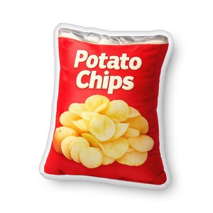 May include: A red pillow shaped like a bag of potato chips. The pillow has the words "Potato Chips" in white block letters. The pillow has a silver top and a white border. The pillow is filled with yellow potato chips.
