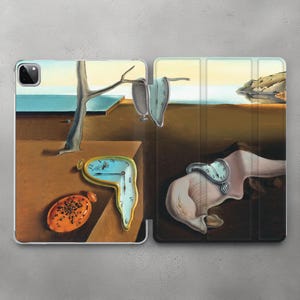 May include: An iPad case featuring a surrealist painting with melting clocks, a tree, and an orange, oval object. The artwork has a brown and blue color palette, with a landscape in the background. The case is designed to protect the iPad.
