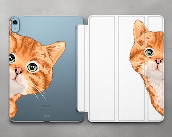 May include: A white iPad case with a cute orange tabby cat peeking out from behind the case. The case has a flap that folds over the front of the iPad. The iPad is labeled "iPad Air".
