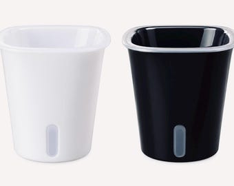 May include: Two square-shaped planters with rounded corners, one in solid white and one in solid black. Each planter features a smooth, glossy finish and a small, vertical, translucent light gray window near the base for monitoring water levels.