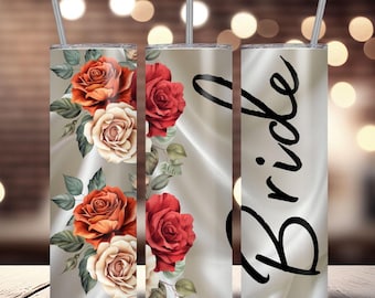 May include: A set of three stainless steel tumblers with straws. Two tumblers feature a floral design with red, orange, and cream roses. The third tumbler has the word "Bride" in black script. The tumblers have a light beige background.