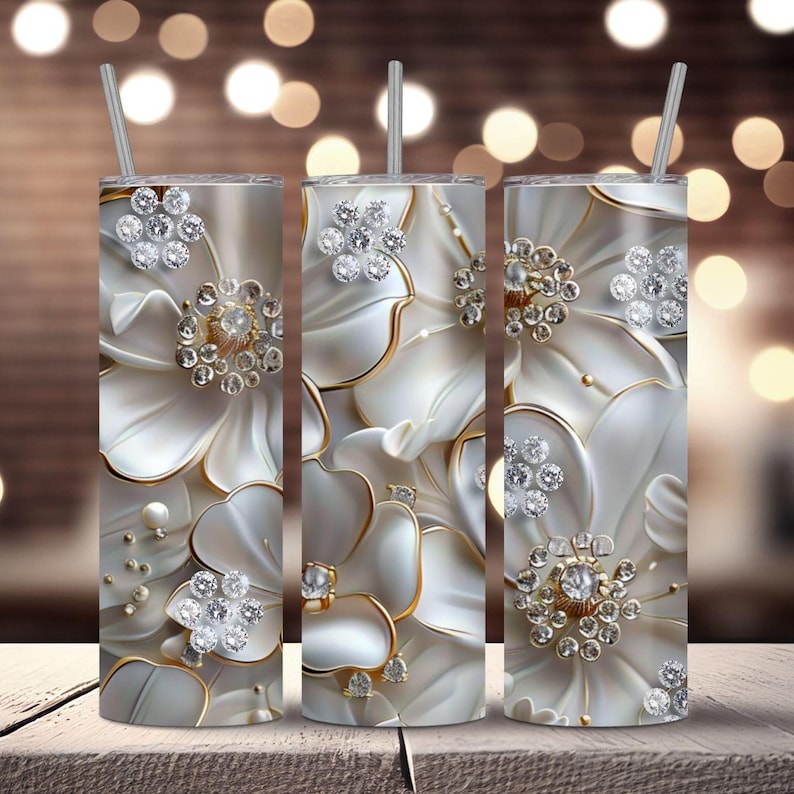 Pu&ograve; includere: Tre bicchieri in acciaio inossidabile con un design floreale bianco e oro con grandi abbellimenti di gioielli decorati.