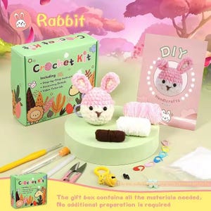 May include: A pink crochet rabbit DIY kit with all the materials needed to make a plush toy. The kit includes yarn, crochet hooks, needles, and instructions. The box says "Crochet Kit" and "Rabbit".