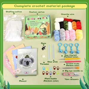 May include: A crochet kit with all the materials needed to make a koala. The kit includes stuffing cotton, chenille wire, yarn, crochet hooks, a needle, a glue stick, eyes, a key ring bell, a mark buckle, and a manual. The kit is packaged in a colorful box with the words "Crochet Kit" on it.