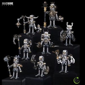 May include: A collection of steampunk-style robot figurines. Each robot is silver with brass and bronze accents, featuring gears, springs, and other mechanical details. The robots are displayed on black platforms against a black background. The text "MACHINE PLANET" is visible.