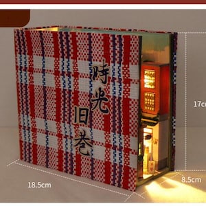 May include: A red and white chequered book-style miniature building with a lit interior. The building is 17 cm tall, 18.5 cm wide, and 8.5 cm deep. The building has a sign that reads "時光旧巷".