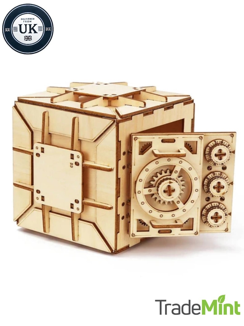 May include: A wooden model of a safe with a working door and a combination lock. The safe is made of light brown wood and has a detailed design. The door is open and the lock is visible. The safe is a fun and challenging project for anyone who enjoys woodworking.