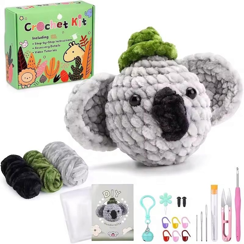 May include: A crochet kit to make a gray koala with a green hat. The kit includes yarn, a crochet hook, stuffing, and instructions. The box says "Crochet Kit" and includes a list of what is included.