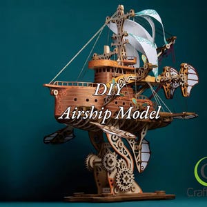 May include: DIY Airship Model kit with intricate wooden details and a green and white patterned sail. The model is on a wooden base and features the text "DIY Airship Model" and the logo "CraftMint".