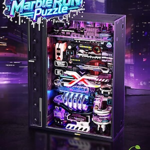 May include: A futuristic marble run puzzle with the text "Build the motion Marble Run Puzzle". The puzzle is housed in a black rectangular case with various tracks, ramps, and obstacles. The design incorporates neon lights and a futuristic aesthetic.
